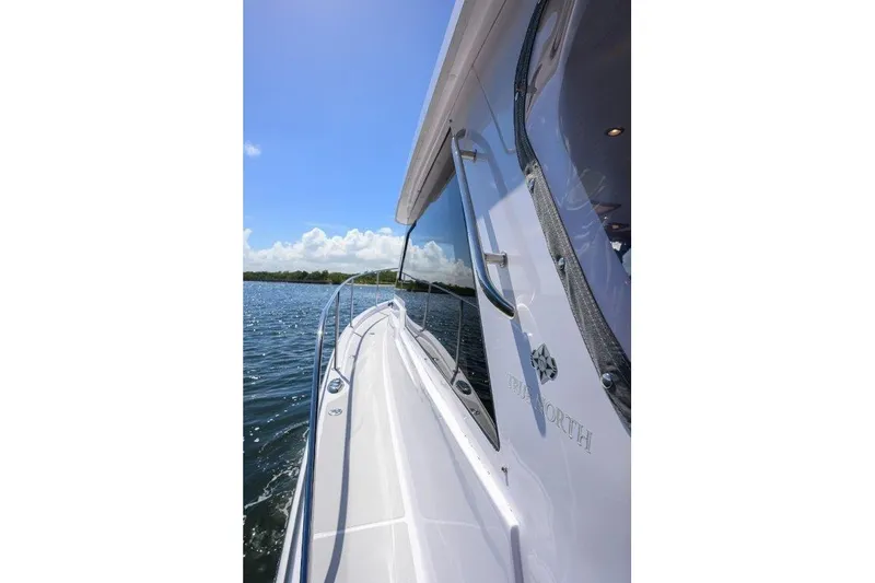 Slide: The Image of 2022 True North 34 boat cruising on a sunny day with clear blue skies. - 37