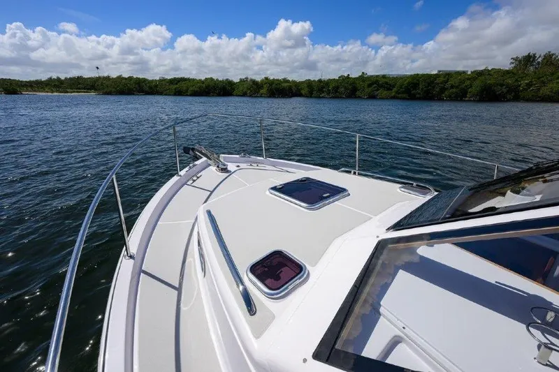Slide: The Image of Bow view of 2022 True North 34 yacht on calm waters under blue sky. - 38