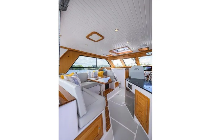 Slide: The Image of Luxurious interior of 2022 True North 34 yacht with elegant seating and panoramic windows. - 46