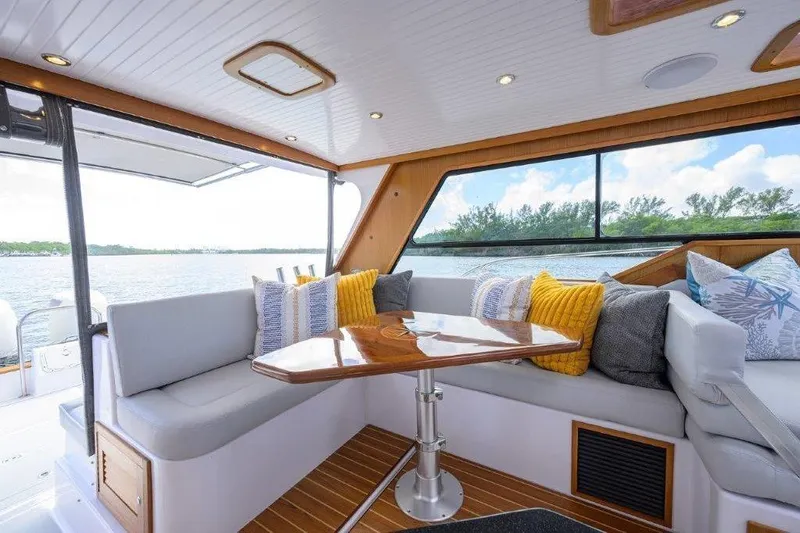Slide: The Image of Luxurious interior of 2022 True North 34 yacht with plush seating and scenic water view. - 49