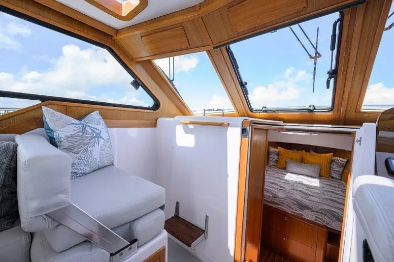 Slide: The Image of Interior of 2022 True North 34 boat with cozy seating and cabin bed. - 59