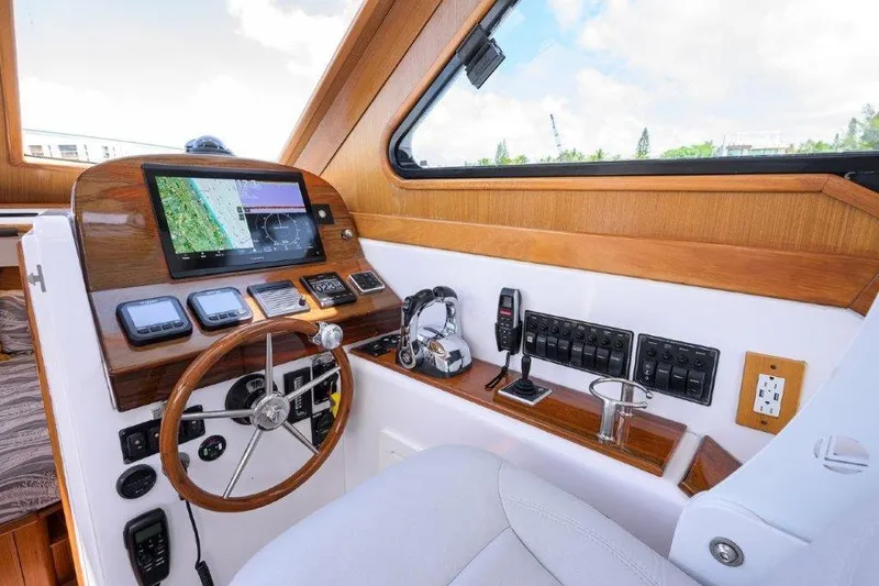 Slide: The Image of Interior helm of 2022 True North 34 boat with navigation equipment and wooden accents. - 62