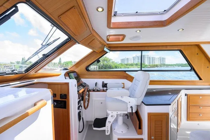 Slide: The Image of Interior of 2022 True North 34 boat with modern helm and scenic water view. - 65