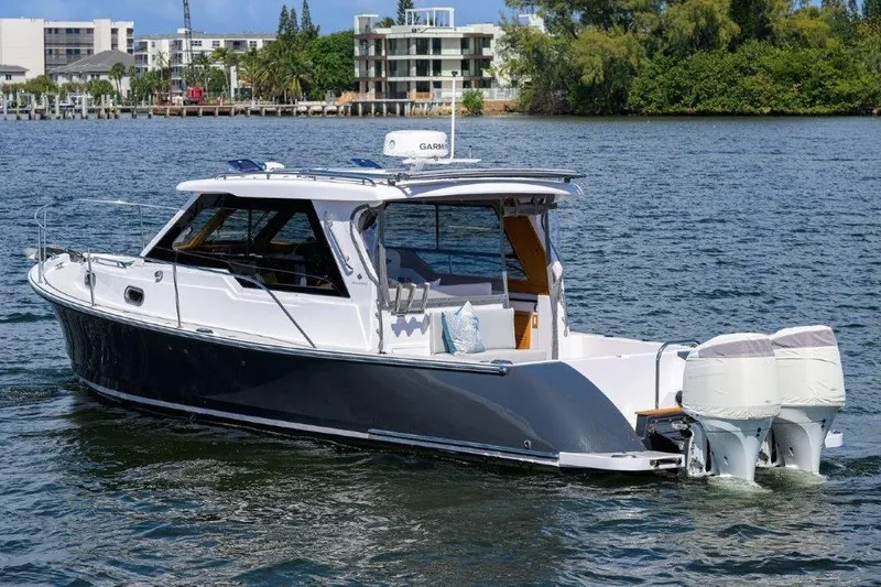 Slide: The Image of 2022 True North 34 boat on water, featuring sleek design and dual outboard engines. - 7