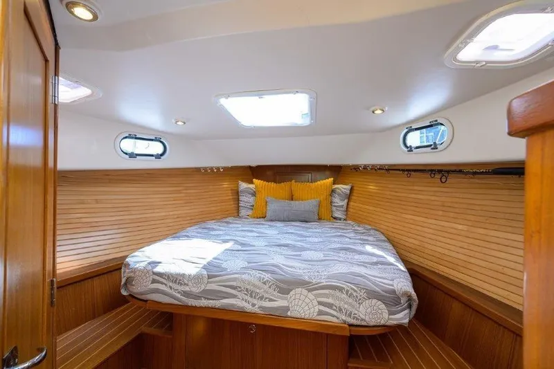 Slide: The Image of Cozy cabin interior of 2022 True North 34 boat with wood paneling and skylights. - 72