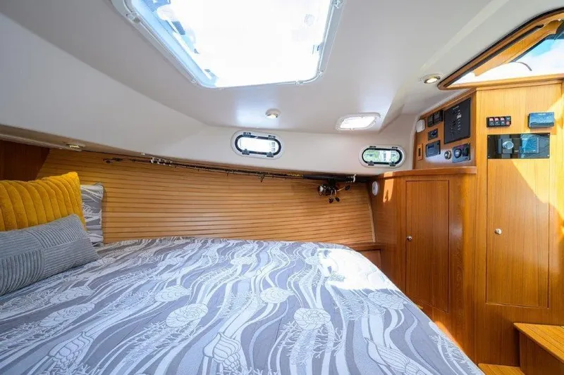 Slide: The Image of Cozy cabin interior of 2022 True North 34 yacht with wood paneling and skylight. - 74