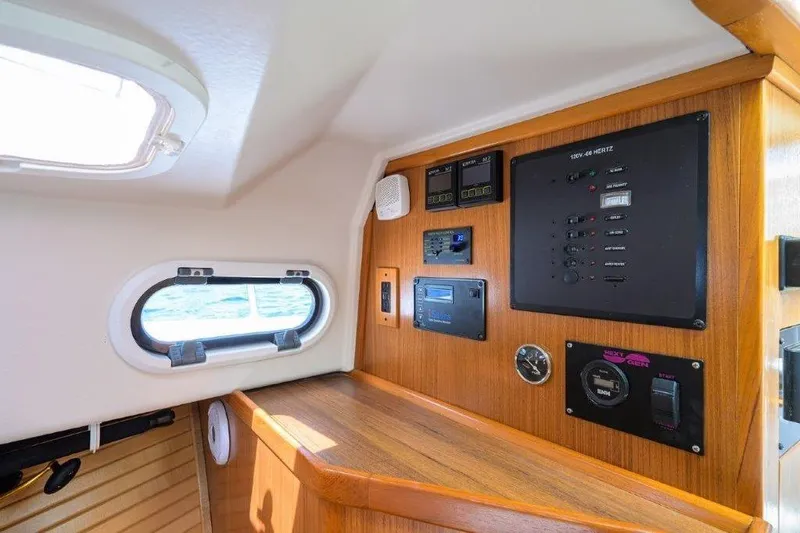 Slide: The Image of Interior of 2022 True North 34 boat with control panel and porthole window. - 76