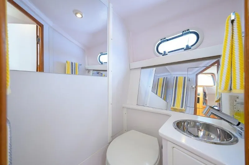 Slide: The Image of Compact bathroom in 2022 True North 34 boat with sink, mirror, and window. - 78