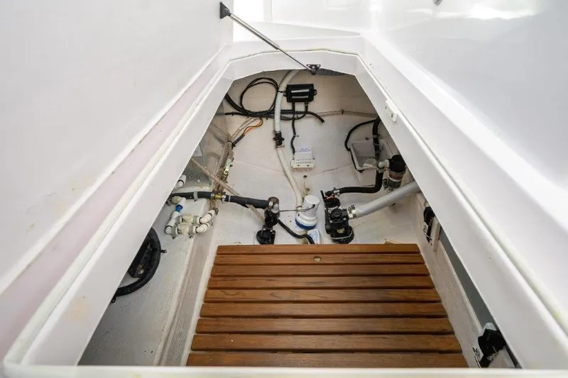 Slide: The Image of Bilge area of 2022 True North 34 boat with wooden flooring and visible plumbing. - 80