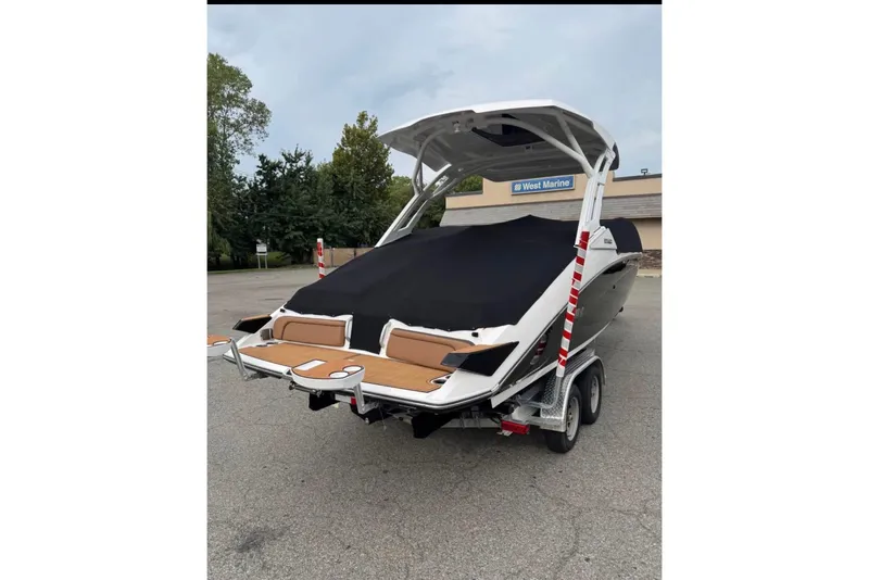 Slide: The Image of 2024 Yamaha Boats 275SD on trailer, covered, parked outdoors. - 8