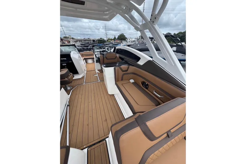 Slide: The Image of 2024 Yamaha Boats 275SD interior with luxurious seating and sleek design. - 9
