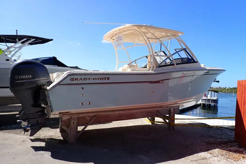 Slide: The Image of 2016 Grady-White Freedom 275 boat with Yamaha engine, docked by the water. - 1