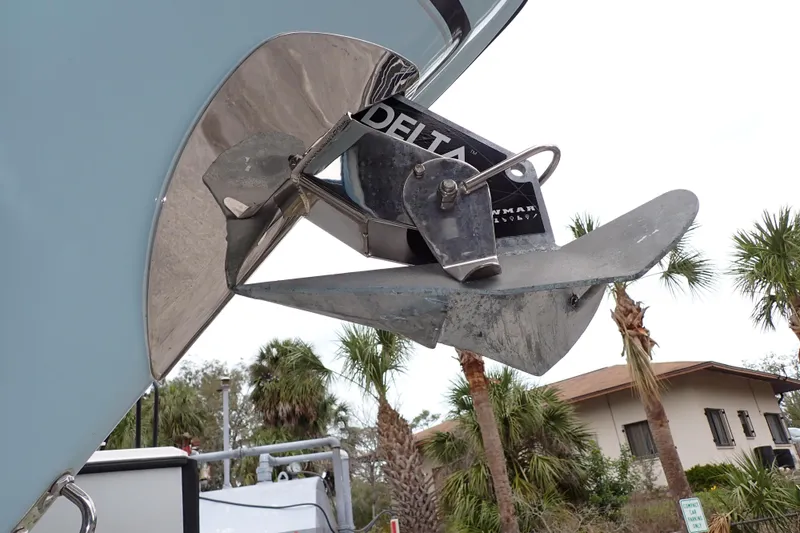 Slide: The Image of 2016 Grady-White Freedom 275 boat anchor with Delta branding, surrounded by palm trees. - 10