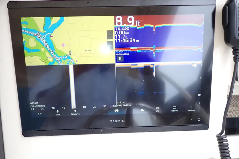 Slide: The Image of Garmin navigation display on 2016 Grady-White Freedom 275 boat, showing map and sonar data. - 11