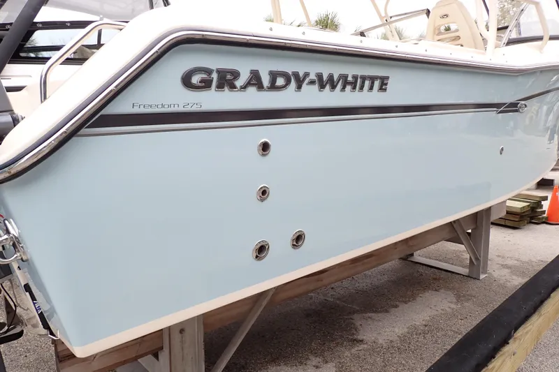 Slide: The Image of 2016 Grady-White Freedom 275 boat side view on display. - 110