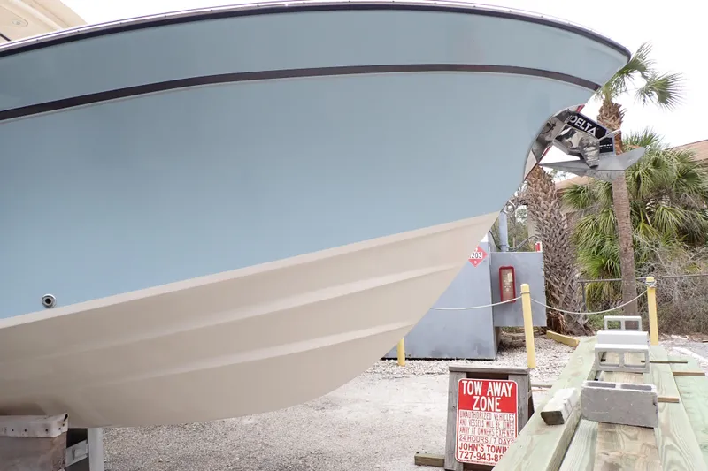 Slide: The Image of 2016 Grady-White Freedom 275 boat in tow-away zone, palm trees in background. - 114