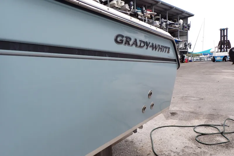 Slide: The Image of 2016 Grady-White Freedom 275 boat at a marina, side view. - 119
