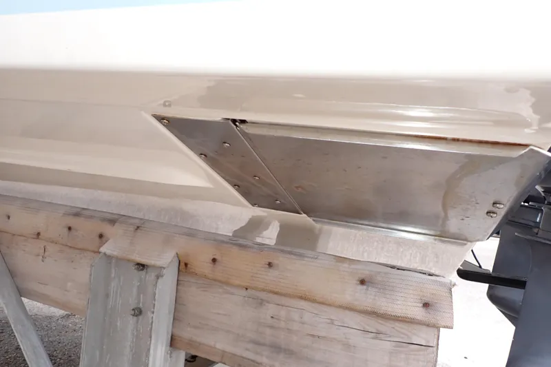 Slide: The Image of 2016 Grady-White Freedom 275 boat hull on wooden support. - 120