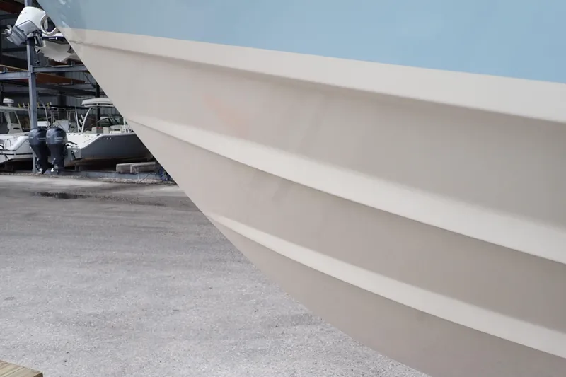 Slide: The Image of 2016 Grady-White Freedom 275 boat hull in a marina setting. - 125