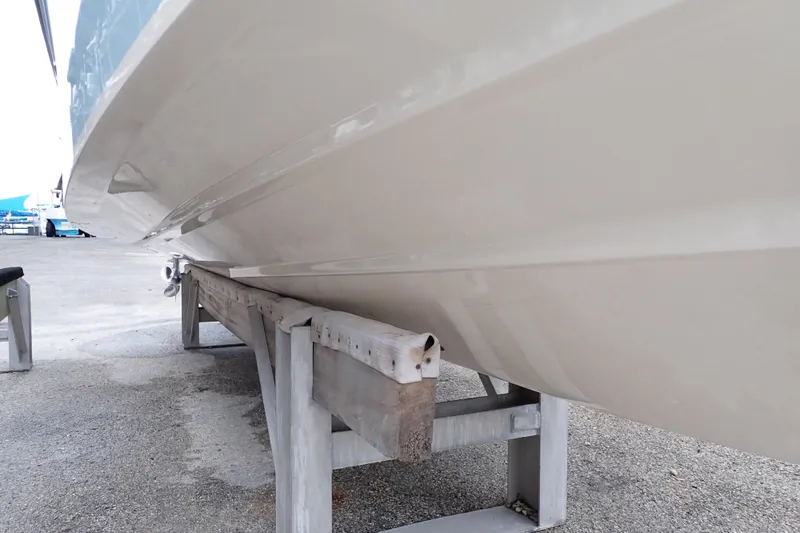 Slide: The Image of 2016 Grady-White Freedom 275 boat hull on a support stand. - 128