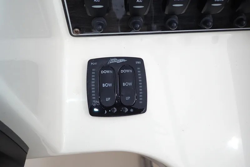 Slide: The Image of Control panel of a 2016 Grady-White Freedom 275 boat, featuring trim tab switches. - 14