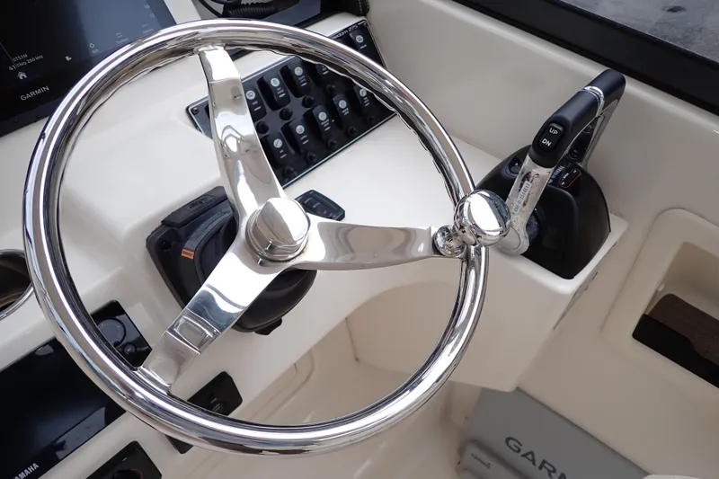 Slide: The Image of Steering wheel and controls of 2016 Grady-White Freedom 275 boat. - 16