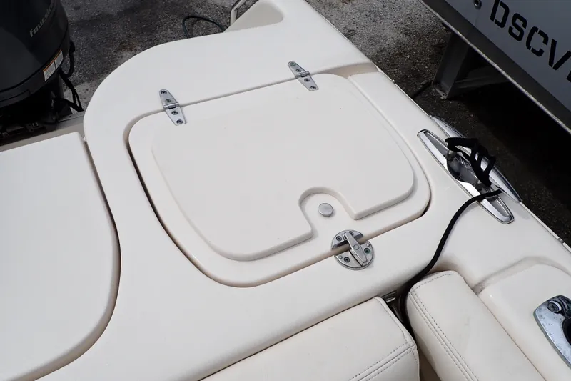 Slide: The Image of 2016 Grady-White Freedom 275 boat deck with storage compartment and cleat. - 22