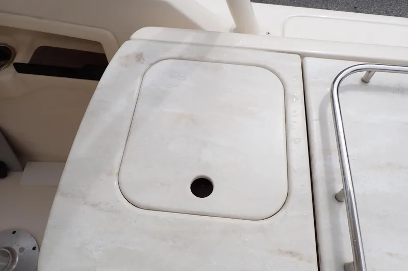 Slide: The Image of 2016 Grady-White Freedom 275 boat deck with storage compartment and railing. - 26