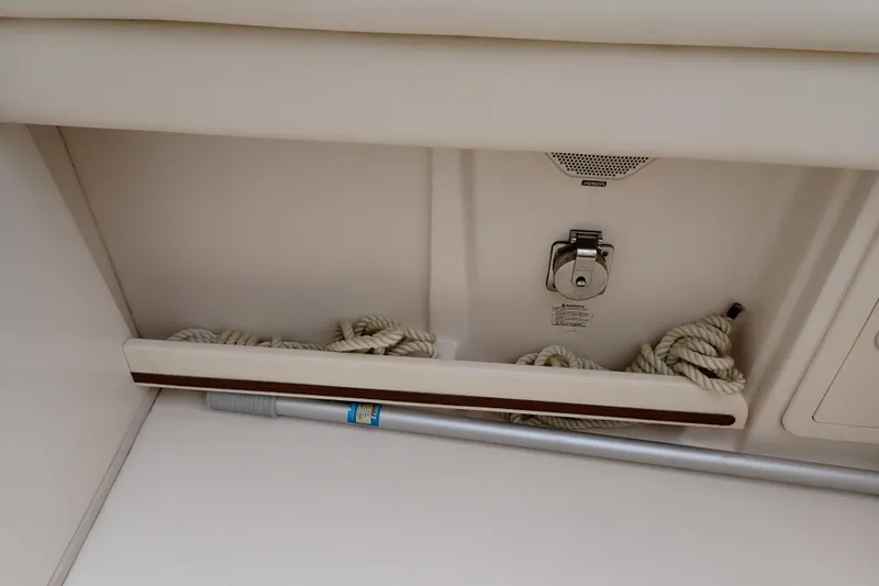 Slide: The Image of Storage compartment on a 2016 Grady-White Freedom 275 boat with ropes and equipment. - 35