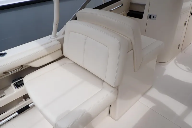Slide: The Image of 2016 Grady-White Freedom 275 boat interior with white seating and sleek design. - 36