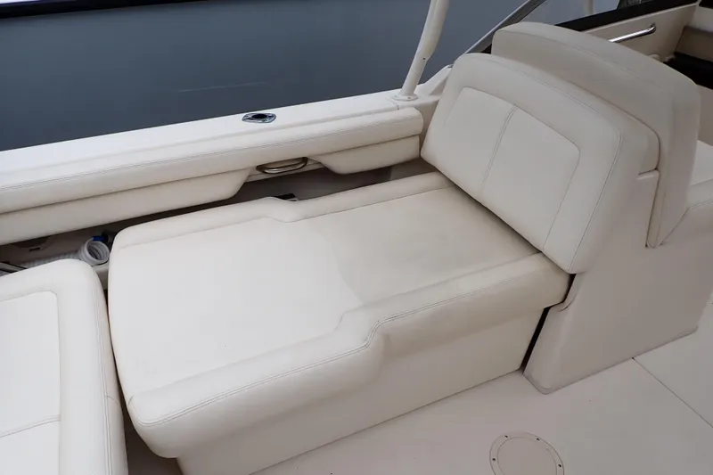 Slide: The Image of 2016 Grady-White Freedom 275 boat interior with white cushioned seating. - 39