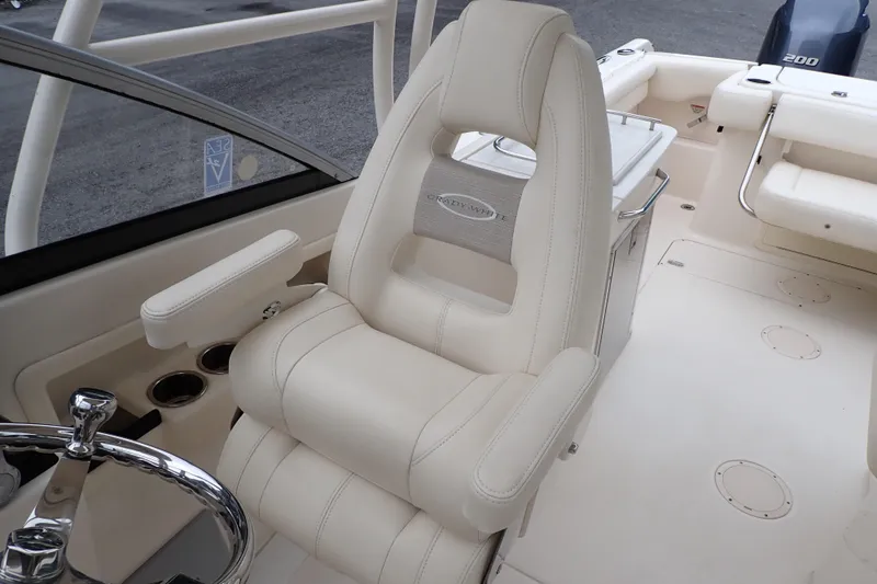Slide: The Image of 2016 Grady-White Freedom 275 boat interior with plush captain's chair and steering wheel. - 42