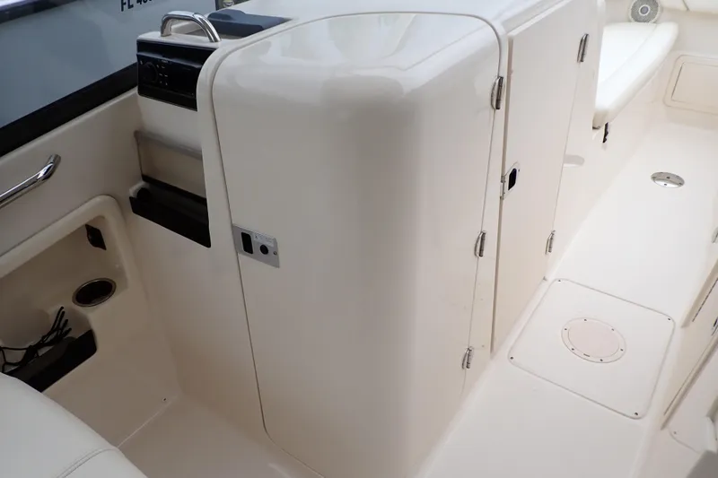Slide: The Image of 2016 Grady-White Freedom 275 boat interior, featuring storage compartments and seating area. - 43