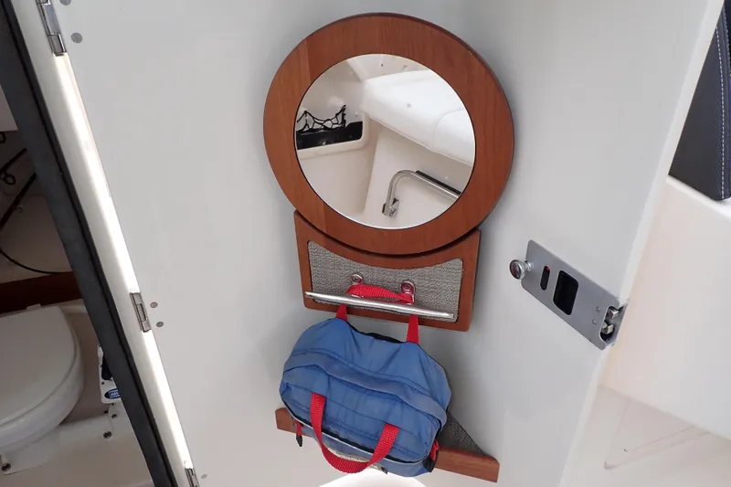 Slide: The Image of Interior of 2016 Grady-White Freedom 275 boat with mirror and storage area. - 44