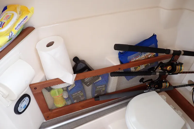 Slide: The Image of 2016 Grady-White Freedom 275 boat storage with fishing rods and cleaning supplies. - 48