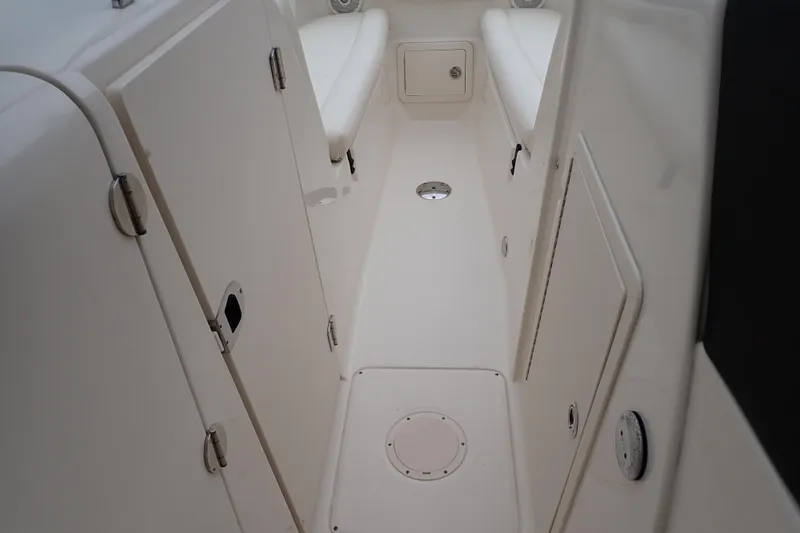 Slide: The Image of 2016 Grady-White Freedom 275 boat interior with storage compartments and seating. - 50