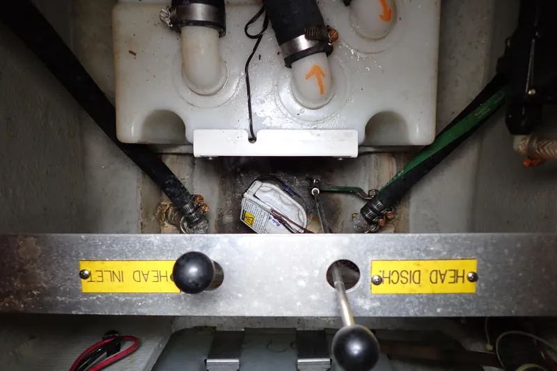 Slide: The Image of 2016 Grady-White Freedom 275 boat plumbing system with labeled head inlet and discharge. - 57