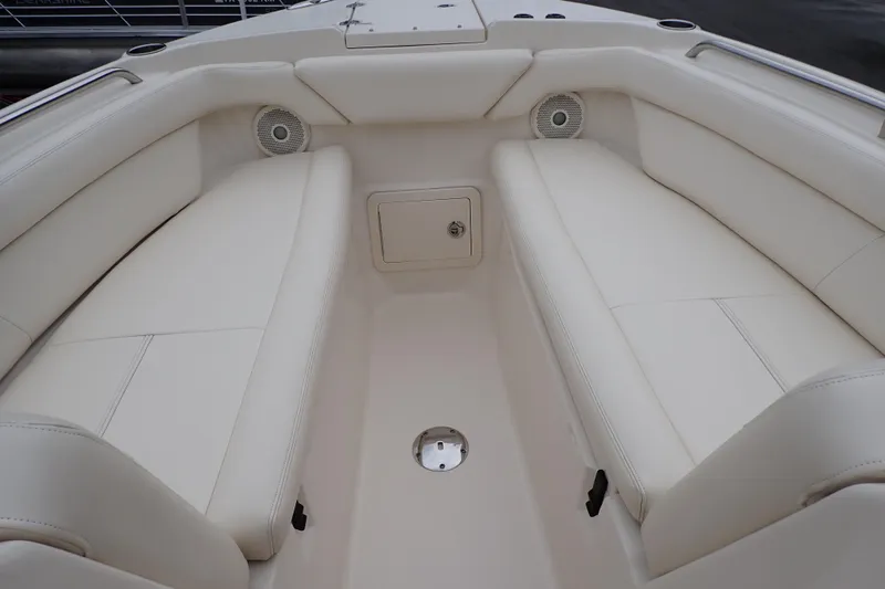 Slide: The Image of 2016 Grady-White Freedom 275 boat interior with white cushioned seating. - 58