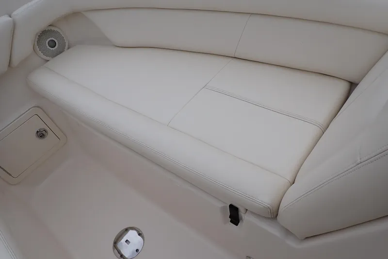 Slide: The Image of 2016 Grady-White Freedom 275 boat interior with white cushioned seating. - 59