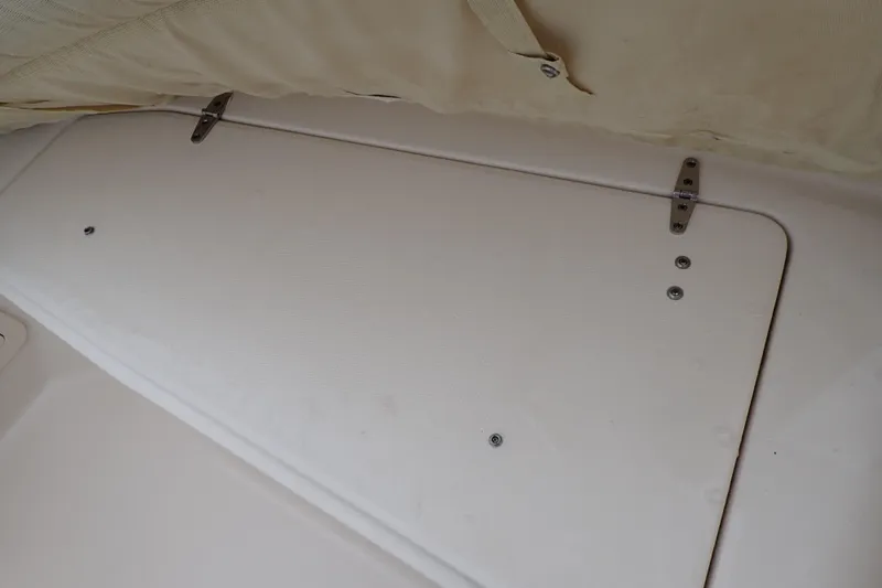 Slide: The Image of 2016 Grady-White Freedom 275 boat storage compartment with secure hinges. - 60