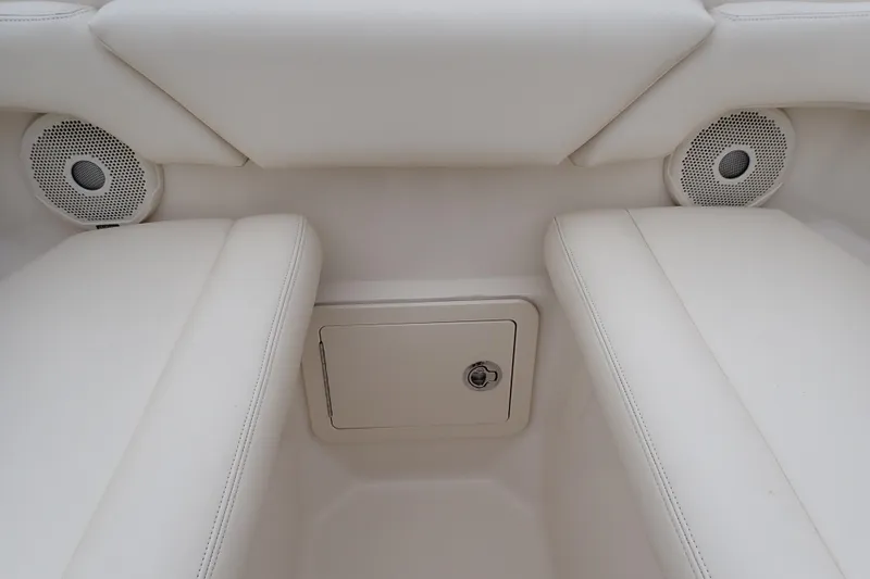 Slide: The Image of 2016 Grady-White Freedom 275 boat interior with white seating and speakers. - 66
