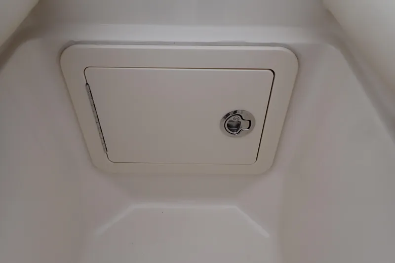 Slide: The Image of Storage compartment on 2016 Grady-White Freedom 275 boat, featuring a secure latch. - 70