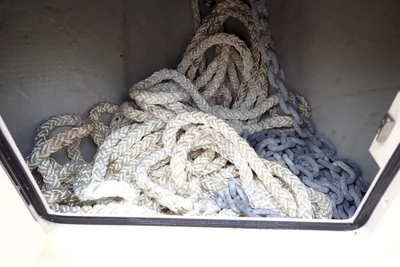 Slide: The Image of Rope and chain storage in 2016 Grady-White Freedom 275 boat compartment. - 71