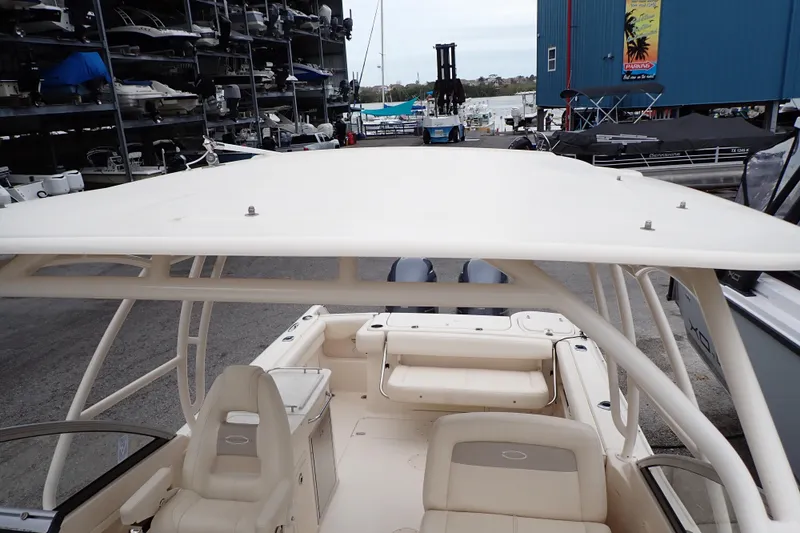 Slide: The Image of 2016 Grady-White Freedom 275 boat interior at marina, showcasing seating and storage. - 72