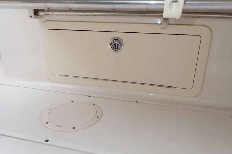 Slide: The Image of Storage compartment on a 2016 Grady-White Freedom 275 boat interior. - 76