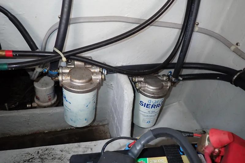 Slide: The Image of Fuel filters and wiring in a 2016 Grady-White Freedom 275 boat engine compartment. - 80