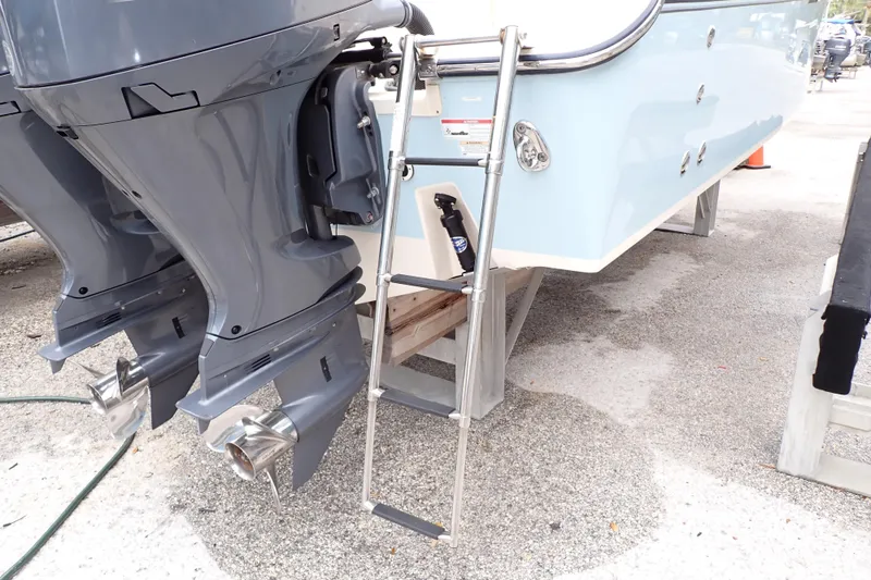 Slide: The Image of 2016 Grady-White Freedom 275 boat with dual outboard motors and boarding ladder. - 94