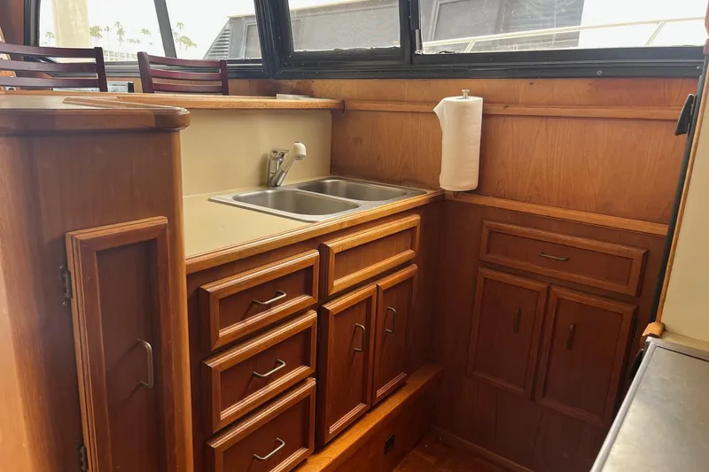 Slide: The Image of 1989 Egg Harbor 41 Convertible yacht kitchen with wooden cabinets and stainless steel sink. - 15