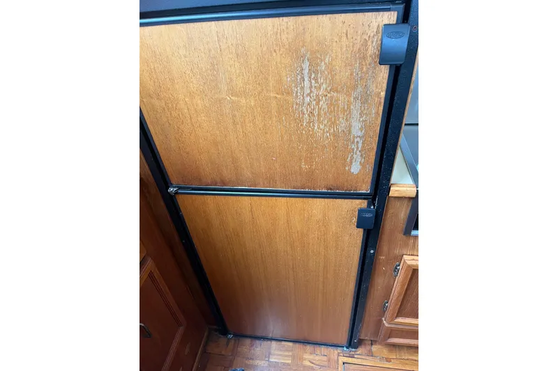 Slide: The Image of Wooden cabinet door on 1989 Egg Harbor 41 Convertible boat interior. - 16