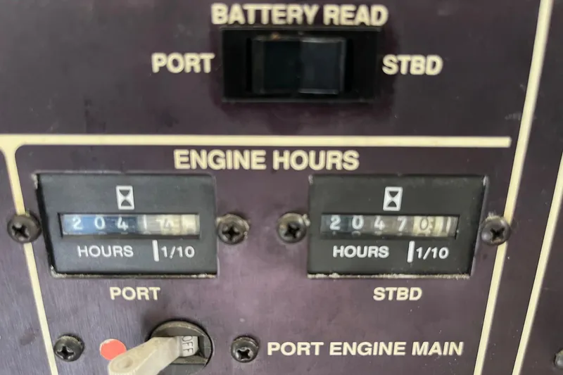 Slide: The Image of Engine hour meters on 1989 Egg Harbor 41 Convertible boat dashboard. - 24